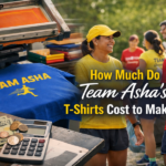 how much do team asha's t-shirts cost to make​